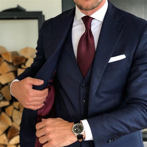 burgundy tie blue suit.